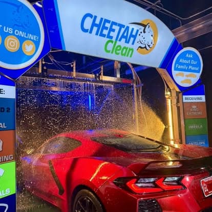 A car rolling through the glowing foam wash tunnel