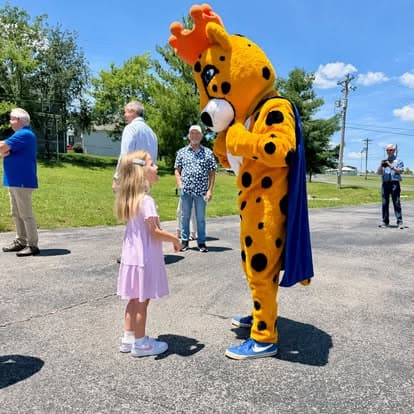 The Cheetah Clean mascot at a community event
